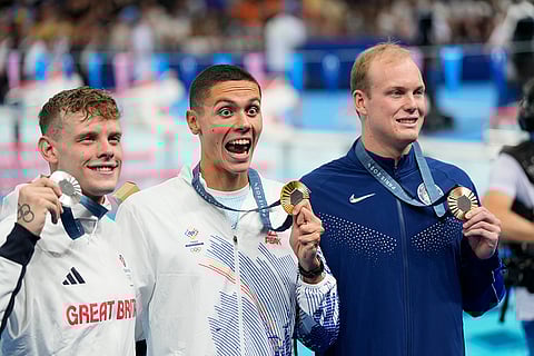 Gold medalist David Popovici with other medal winners